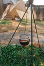 Iron pot soup hang on metal campfire Royalty Free Stock Photo