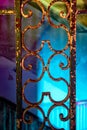 a iron railing with an intricate design in the middle and purple background Royalty Free Stock Photo