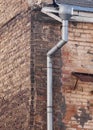 Iron rain gutter on a brick wall. Royalty Free Stock Photo