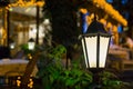 Iron retro lantern with frosted glass and soft warm light. Royalty Free Stock Photo