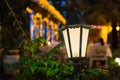 Iron retro lantern of street lighting glowe with warm light. Royalty Free Stock Photo