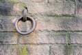 Iron ring in a wall of reddish sandstone, background concept for strength, stability or remaining with copy space