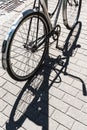 Iron road bicycle on a city street, casting a shadow in the sunlight