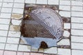 Iron round manhole cover in a puddle of water. Royalty Free Stock Photo