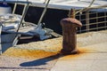 Iron rusty bitt at port Royalty Free Stock Photo