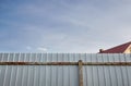 Iron rusty fence. White corrugated metal or zinc texture surface or galvanize steel in the vertical line background Royalty Free Stock Photo