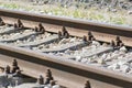 Iron rusty railway track detail over pebbles, shallow depth of field Royalty Free Stock Photo