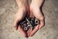 Iron rusty tools bolts and screws in mans hands.