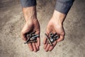 Iron rusty tools bolts and screws in mans hands. Royalty Free Stock Photo