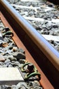 Iron rusty train railway detail over dark stones Royalty Free Stock Photo