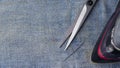 Iron, scissors and a needle to the damaged denim. Repair of jeans at home