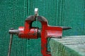 iron shabby clamp vise in the workshop on the table