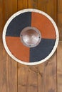 Iron shield on wooden wall