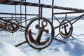 Iron sign of ancor on winter coast covered by snow Royalty Free Stock Photo
