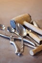 Iron spoons and other tableware lying on a concrete worktop