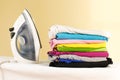 Iron stands with stacks of ironed colored linen. Pile of clothes Royalty Free Stock Photo