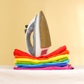 Iron stands with stacks of ironed colored linen. Pile of clothes Royalty Free Stock Photo