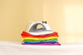 Iron stands with stacks of ironed colored linen. Pile of clothes Royalty Free Stock Photo