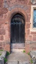 Iron studded wooden door to an old church.  The wood is weathered with age Royalty Free Stock Photo