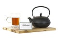 Iron tea pot, teaglass, tea and welcome