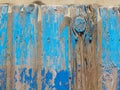 Iron with aged paint of different colors and rust and two rusty nuts