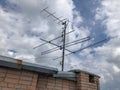 Iron tv antenna on house roof for receiving tv signal.