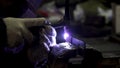 Iron welding with bright light and smoke at manufacturing. Clip. Industrial worker man at the factory welding close up Royalty Free Stock Photo