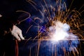 Iron welding close-up, sparks do not wear gloves. Welding sparks and fumes It can be dangerous to health