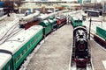 Iron wheels of stream engine locomotive train on railways track perspective to golden light forward use for old and classic period Royalty Free Stock Photo