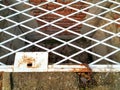 Iron white bars. Closes the entrance to the basement of a brick house. There are key holes in the panel. The fence is closed with Royalty Free Stock Photo