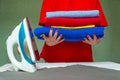 Iron and woman's hands holding the pile of colorful clothes Royalty Free Stock Photo