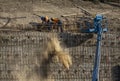 Iron workers shoveling dirt on wall of rebar and steel beams on freeway construction project Royalty Free Stock Photo