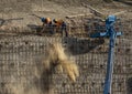 Iron workers on wall of rebar and steel beams on freeway construction project