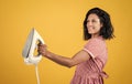 Iron works everywhere. retro girl with electric iron. vintage woman ironing clothes. housekeeping. pinup girl use Royalty Free Stock Photo