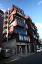 Modern rusty Ironbank with piled up boxes and glass windows. Mixed-used development on Karangahape Road, Auckland, New Zealand Royalty Free Stock Photo