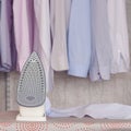 Ironed items and iron on ironing board Royalty Free Stock Photo