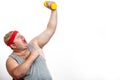 Fat funny man in red headband shows his muscles with dummbell and emotions Royalty Free Stock Photo