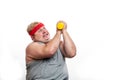 Fat funny man in red headband shows his muscles with dummbell and emotions Royalty Free Stock Photo