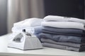 Ironing, laundry, clothes, housekeeping and objects concept - close up of ironed and folded shirts on table