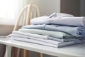 Ironing, laundry, clothes, housekeeping and objects concept - close up of ironed and folded shirts on table Royalty Free Stock Photo