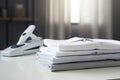 Ironing, laundry, clothes, housekeeping and objects concept - close up of ironed and folded shirts on table Royalty Free Stock Photo