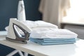 Ironing, laundry, clothes, housekeeping and objects concept - close up of ironed and folded shirts on table Royalty Free Stock Photo