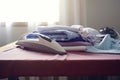 Ironing, laundry, clothes, housekeeping and objects concept - close up of ironed and folded shirts on table Royalty Free Stock Photo