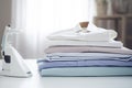 Ironing, laundry, clothes, housekeeping and objects concept - close up of ironed and folded shirts on table Royalty Free Stock Photo