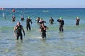 Ironman competitors exit ocean in Panama City Beach, Florida.