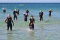 Ironman competitors exit ocean in Panama City Beach, Florida.