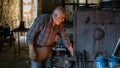 Ironsmith working in his workshop in Adiyaman city historical old Oturakci bazaar inside the old city, Turkey Royalty Free Stock Photo