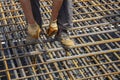 Ironworker securing steel rebar framing with wire plier cutter