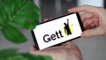 IRPEN, UKRAINE - JANUARY 20 20223, Closeup of smartphone screen Gett logo lettering with in man's hands