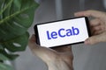 IRPEN, UKRAINE - JANUARY 20 20223, Closeup of smartphone screen LeCab logo lettering with in man's hands